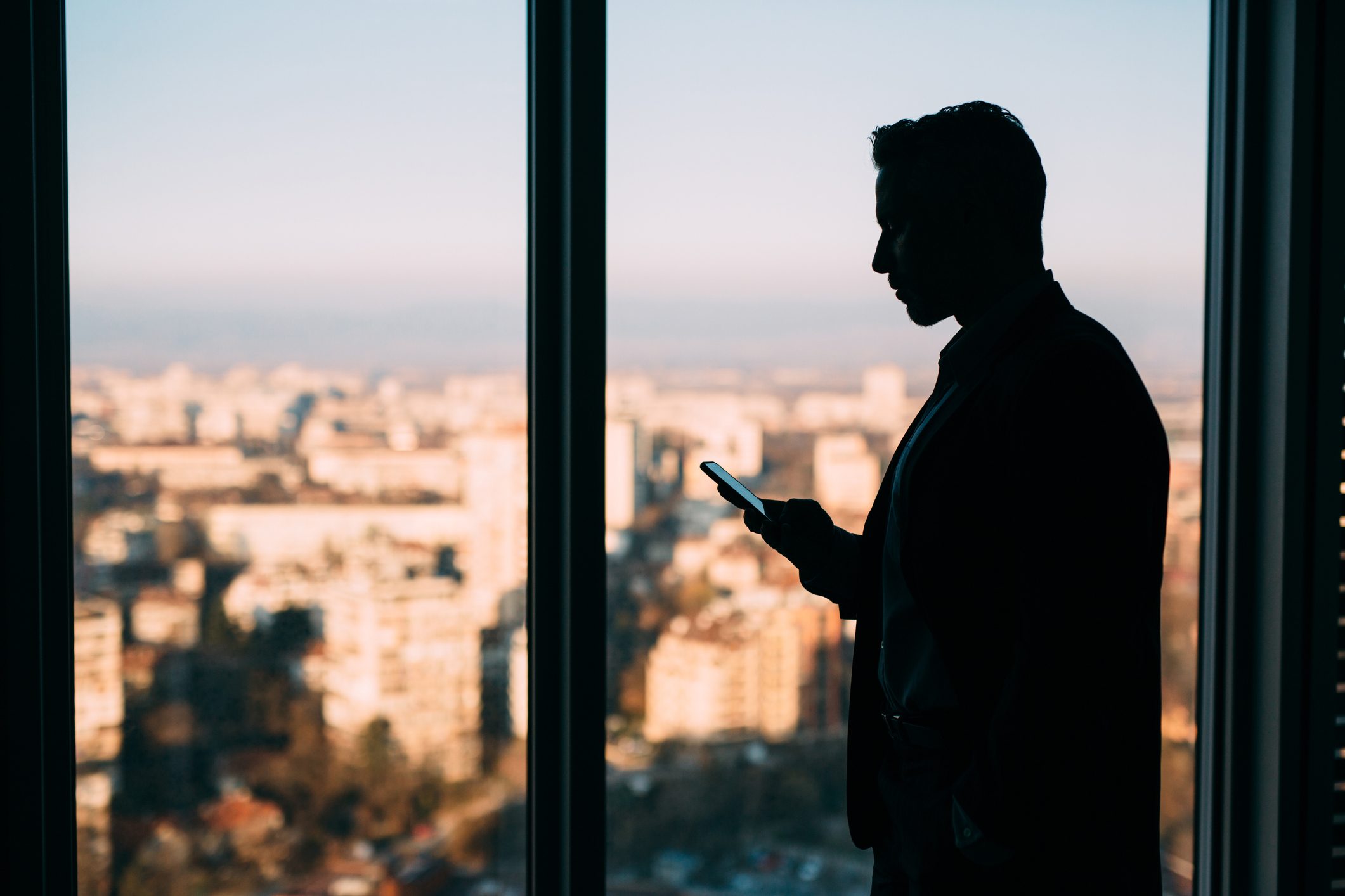Businessman Texting At The Window