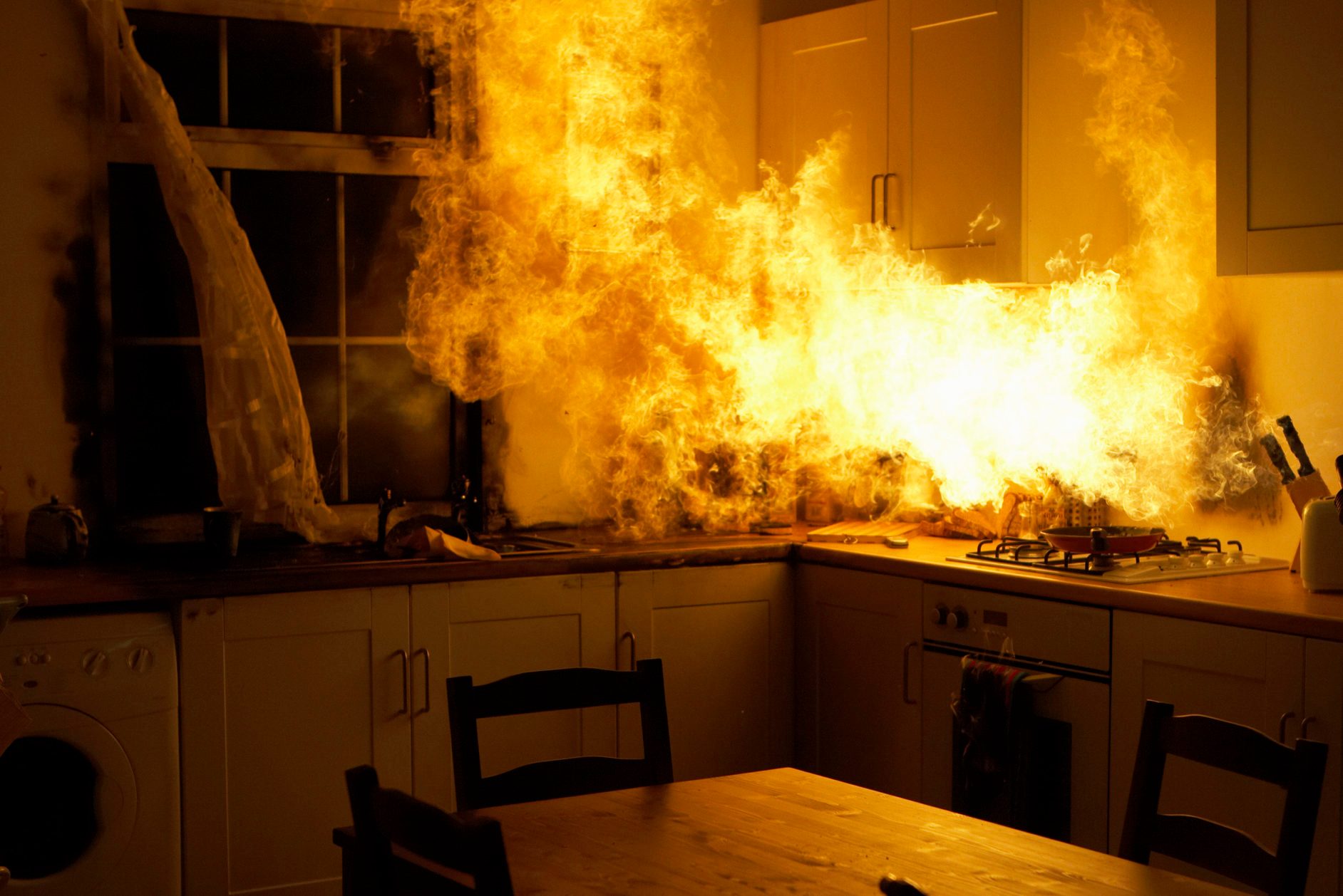 Fire raging in domestic kitchen at night