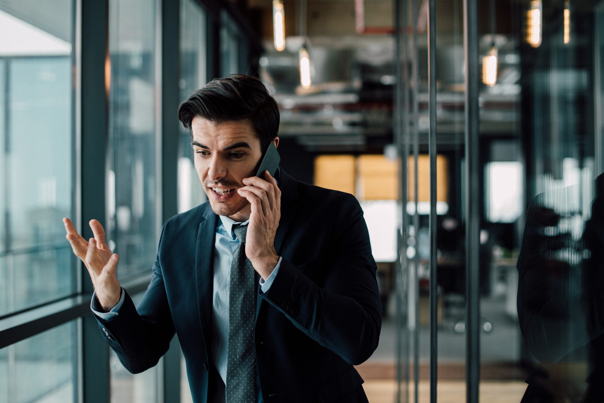 Amazed businessman annoyed with phone call