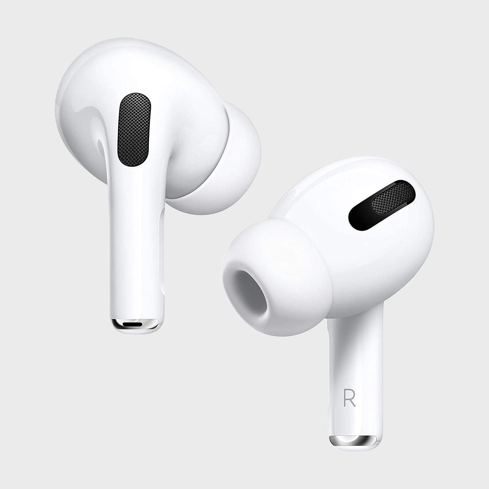 White wireless earbuds with silicone tips rest side by side on a plain gray background, each showing black speaker grilles.
