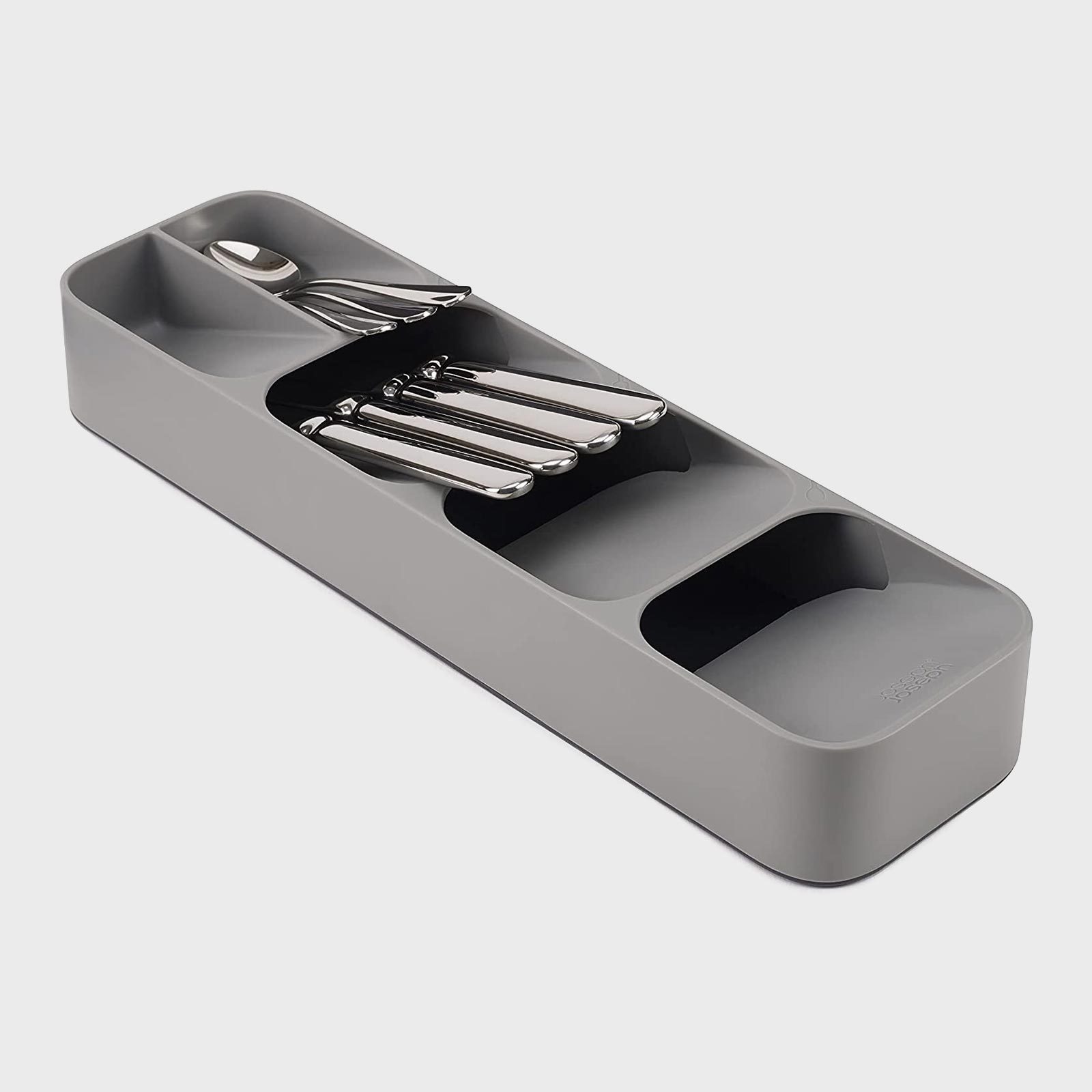 Tray holding four neatly stacked silverware pieces, organized within a compact, gray plastic holder, against a plain light background.