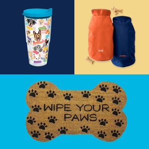 Tumbler displays dog illustrations with breed names; colorful dog jackets labeled â€œZoeâ€ and â€œTuckerâ€ lie beside dog treats; bone-shaped mat reads 