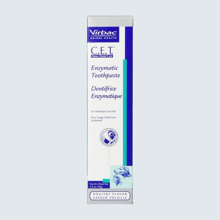 Toothpaste box displaying text about enzymatic toothpaste for pets, with poultry flavor indication, veterinary use only, and animal illustrations.