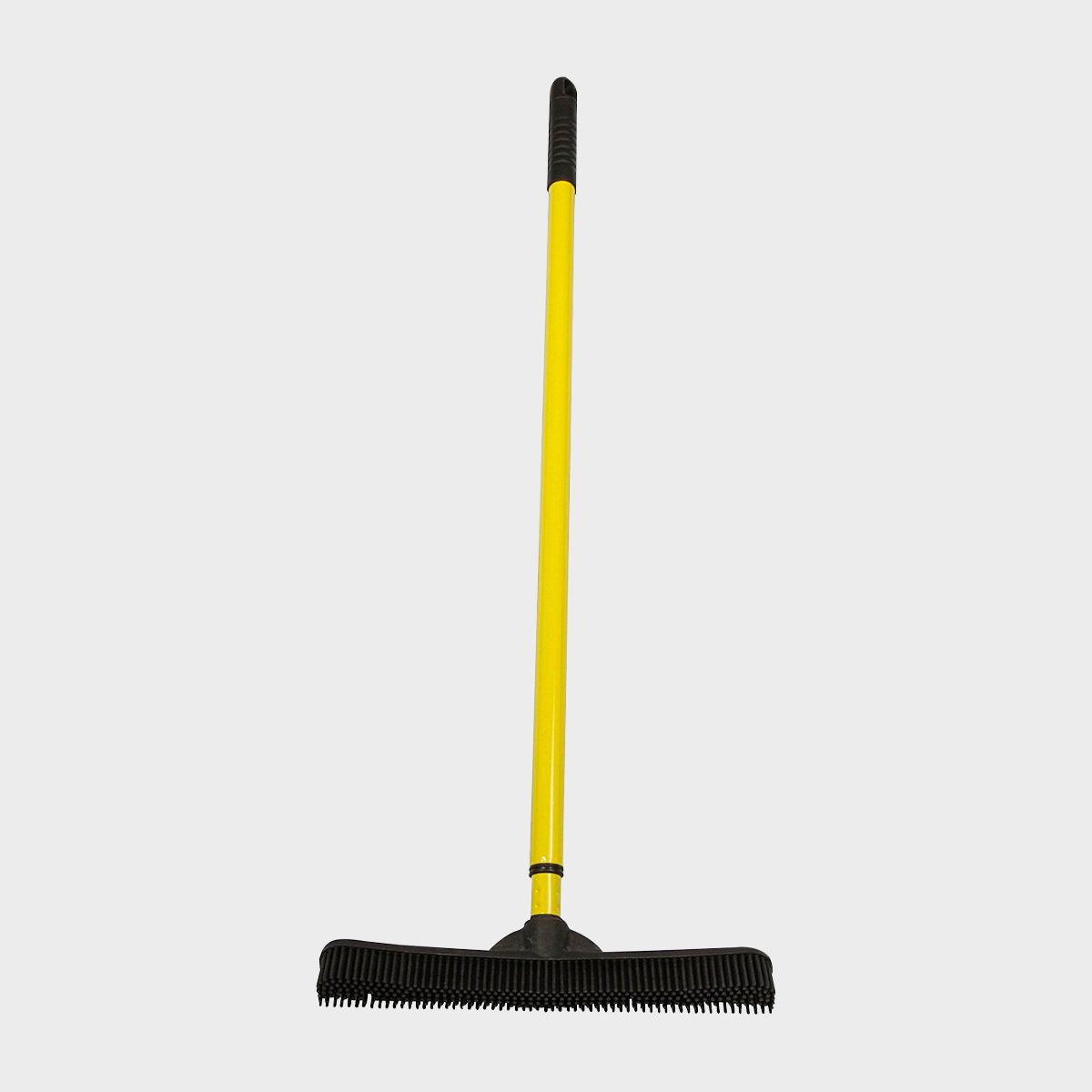 Yellow broom with a rubber bristle head stands upright against a plain gray background.