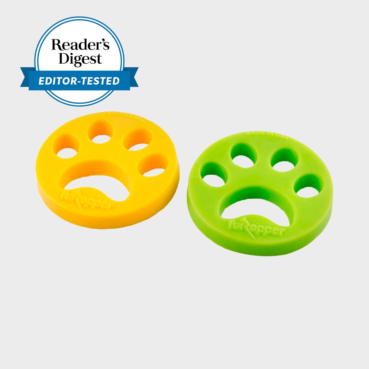 Yellow and green paw-shaped tools rest side by side, featuring several circular cutouts, labeled "FurZapper." Marked as "Reader's Digest Editor-Tested."