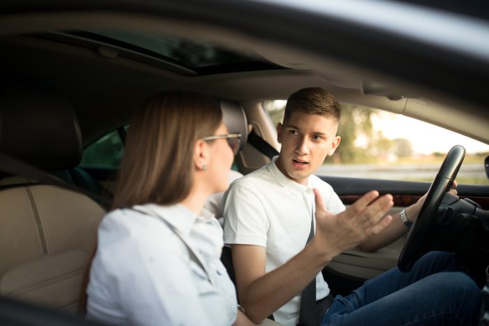 Young couple fighting in car