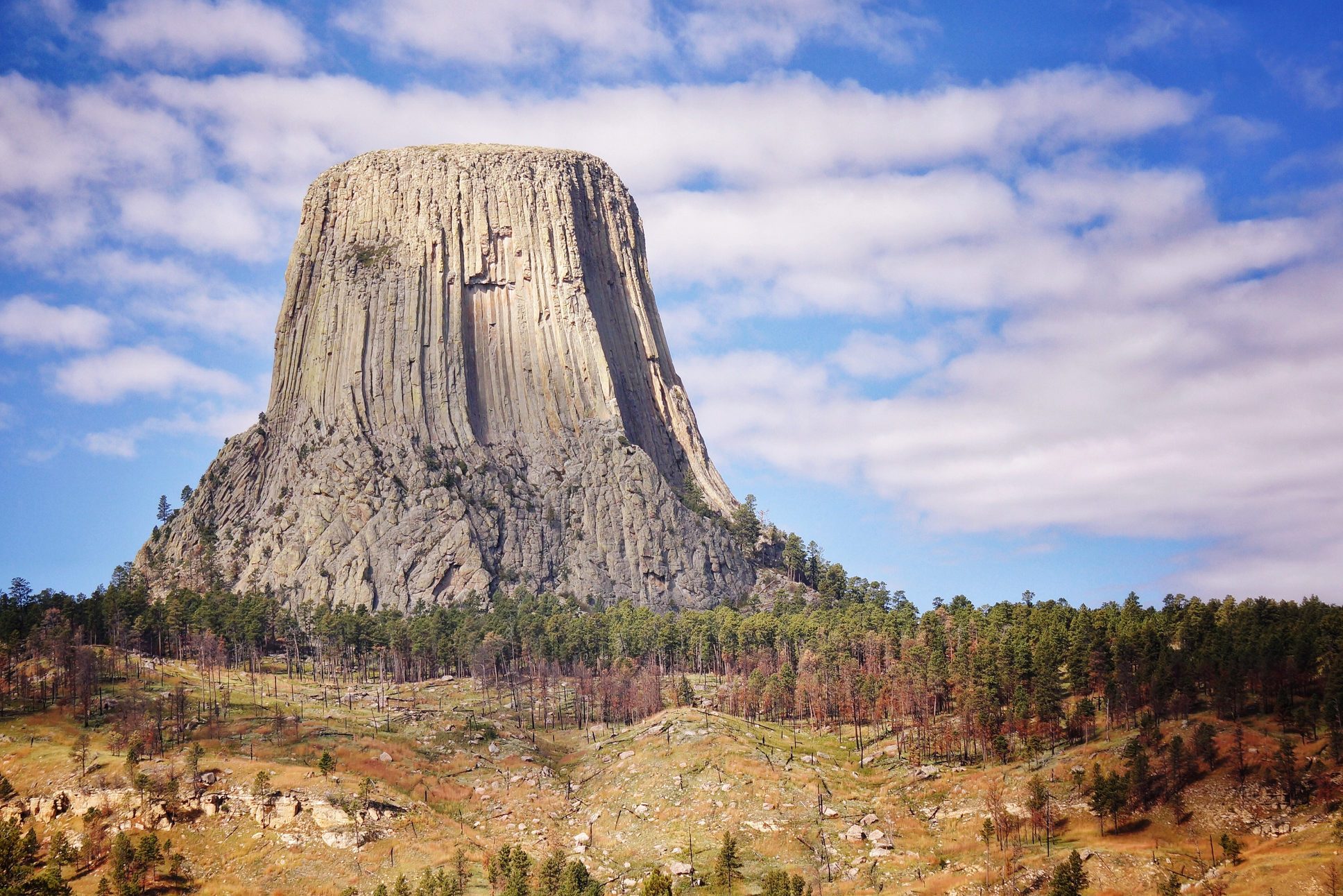 Low Angle View Of Devils Tower National Monument Against Cloudy Sky