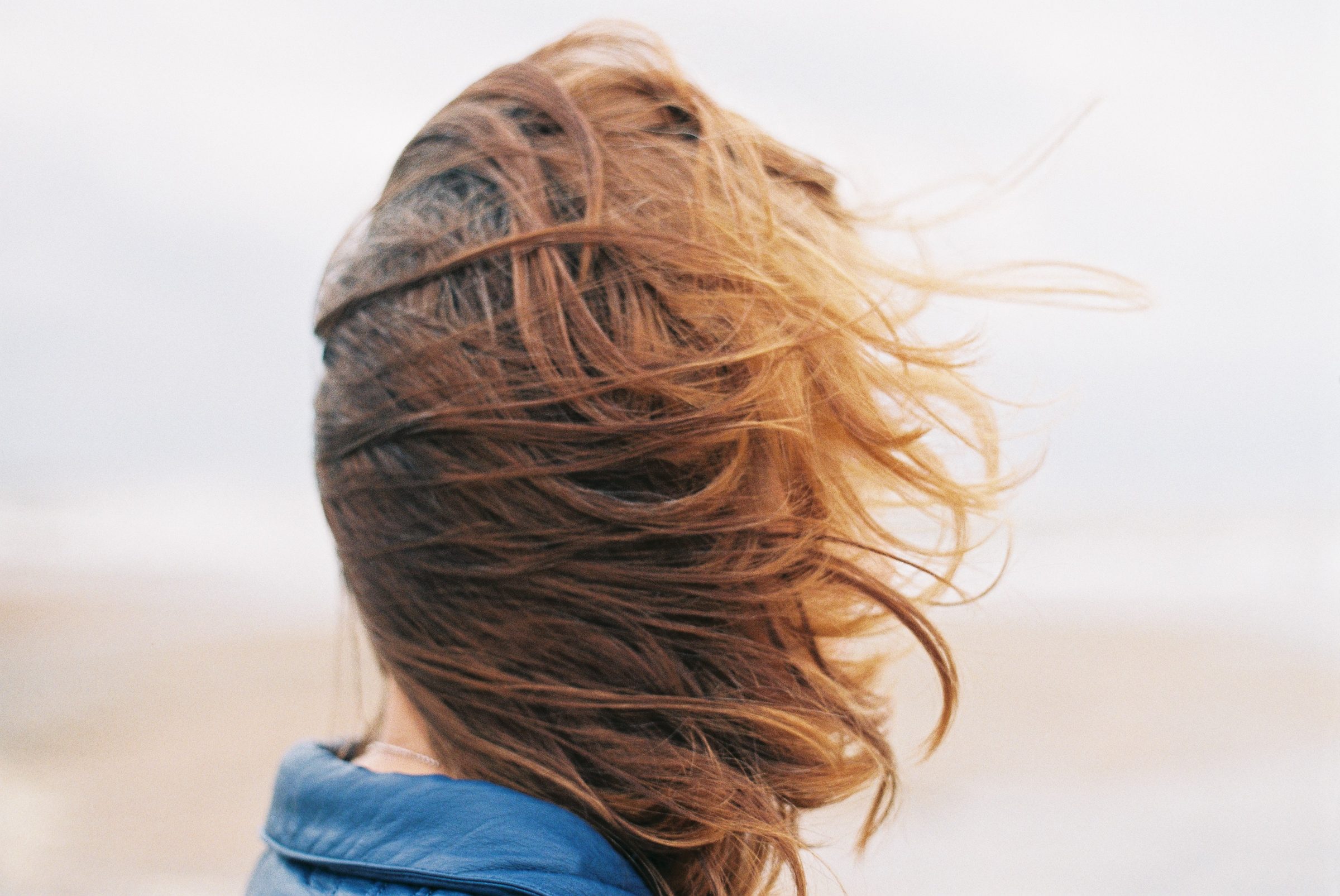 Close-up of a woman with windswept hair