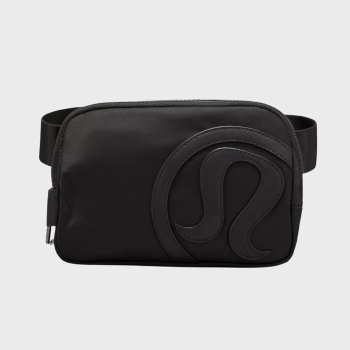 A black zippered pouch with a large embossed symbol sits against a plain, light gray background.