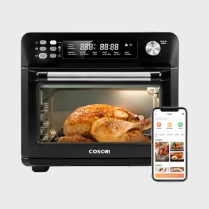 Oven cooking seasoned chicken inside, LED screen displays settings; smartphone app nearby shows recipes, enhancing the cooking experience.