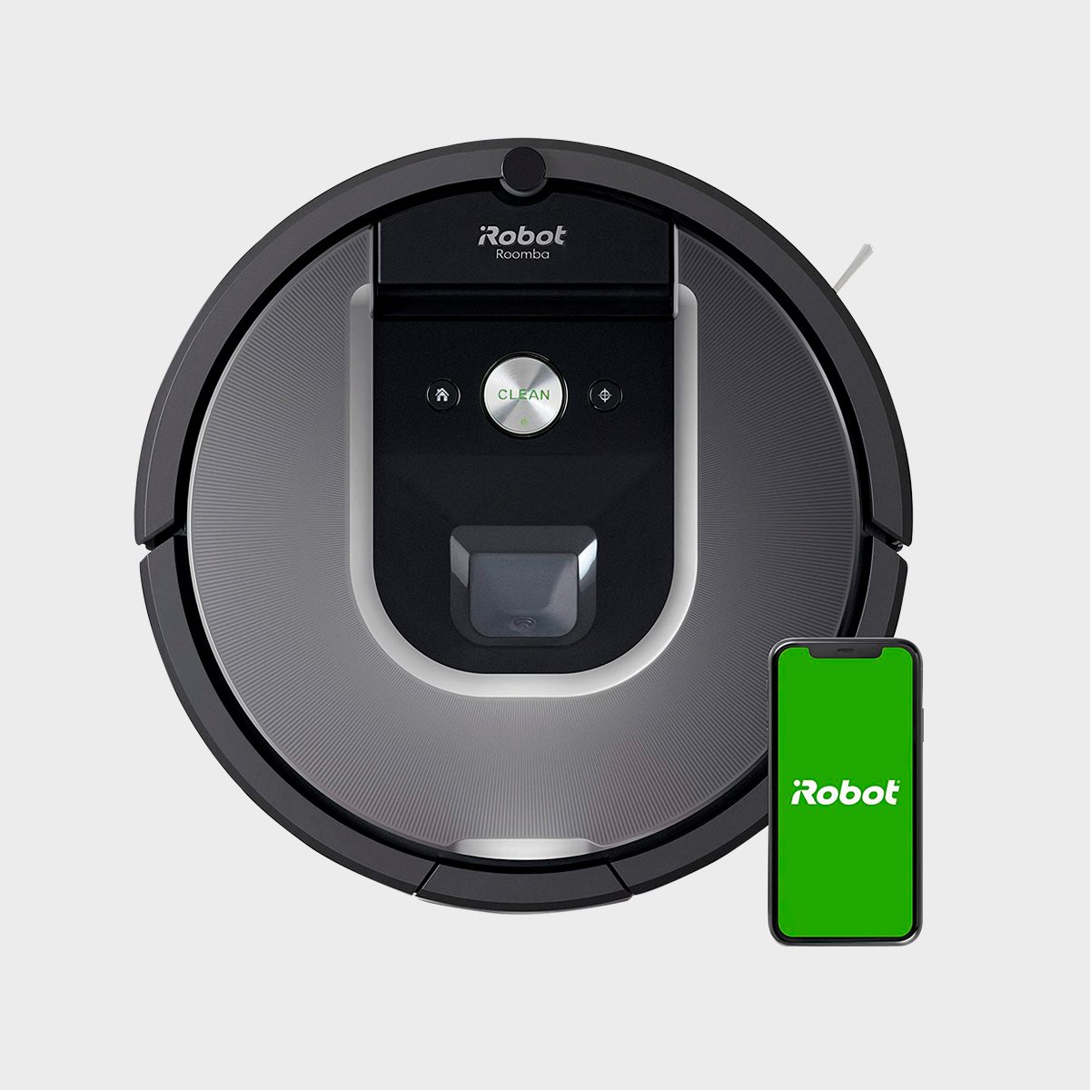 Robot vacuum paused beside a smartphone displaying a green screen with "iRobot" text, set against a plain background.