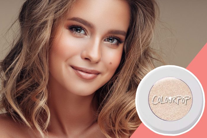 Woman smiling, wearing natural makeup; beige background. Inset shows 