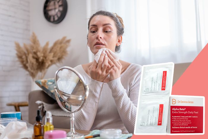 A person applies a facial wipe, sitting by a vanity with skincare items, reflecting in a mirror. Text: â€œDr. Dennis Gross Alpha Beta Daily Peel.â€