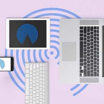 Devices displaying blue concentric circle icons arranged on a light purple surface; includes a smartphone, tablet, laptop, and wireless keyboard.