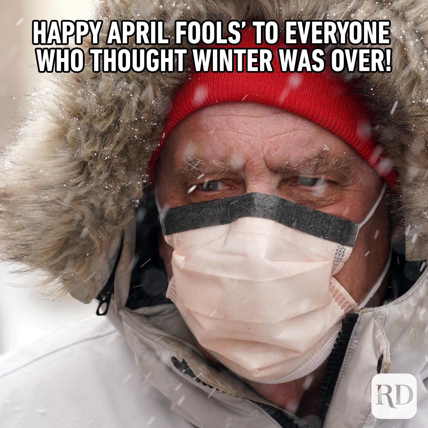 Man wearing a mask in the snow. Meme text: Happy April Fools’ to everyone who thought winter was over!