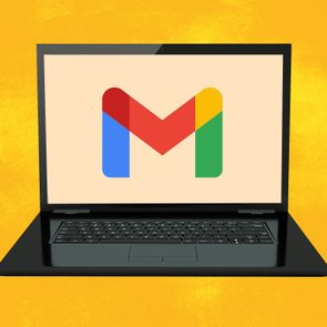 Laptop displaying Gmail logo; positioned against a bright yellow background.