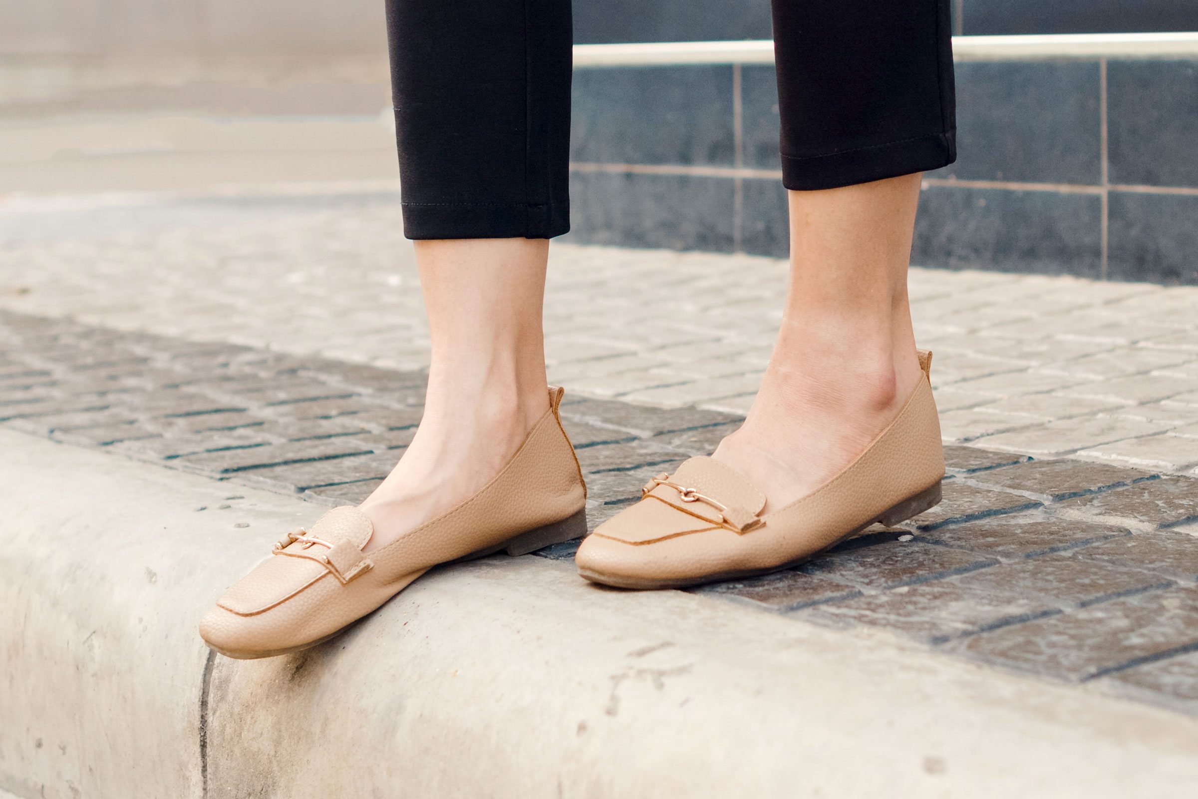 woman wearing dress pants with tan shoes and ankles showing