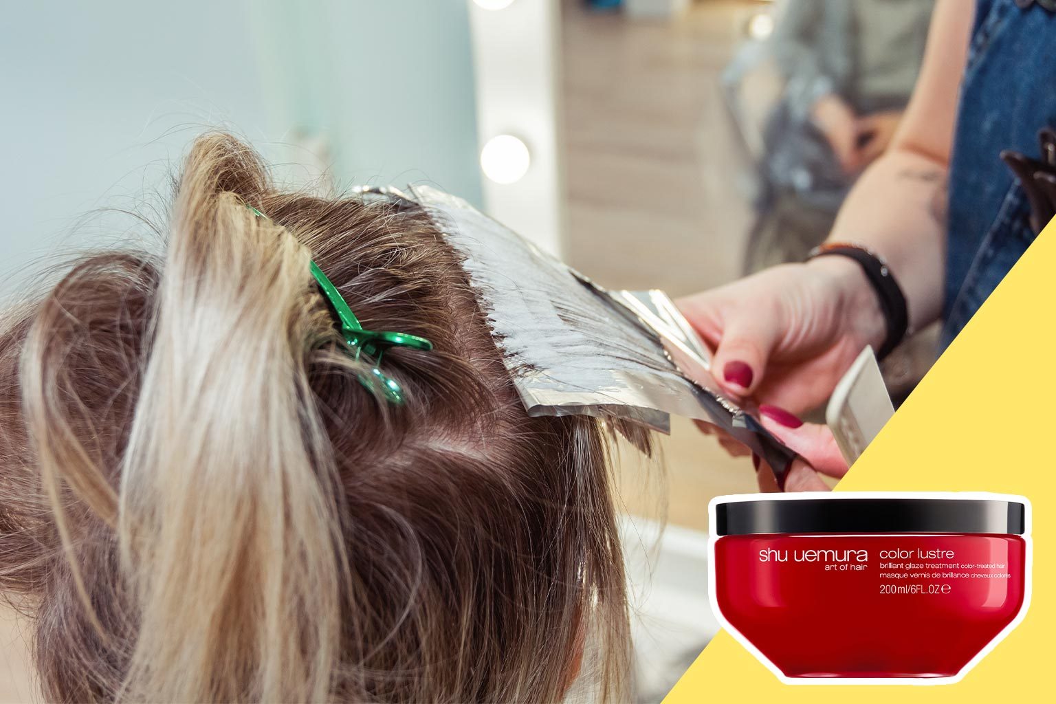 Hair being colored with foil in a salon; a hand applies dye. A red container labeled "shu uemura: color lustre" is visible.
