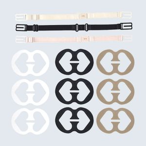 Straps lay flat, showcasing various colors; circular clips in white, black, beige arranged, each with symmetrical cutouts, against a plain light background.