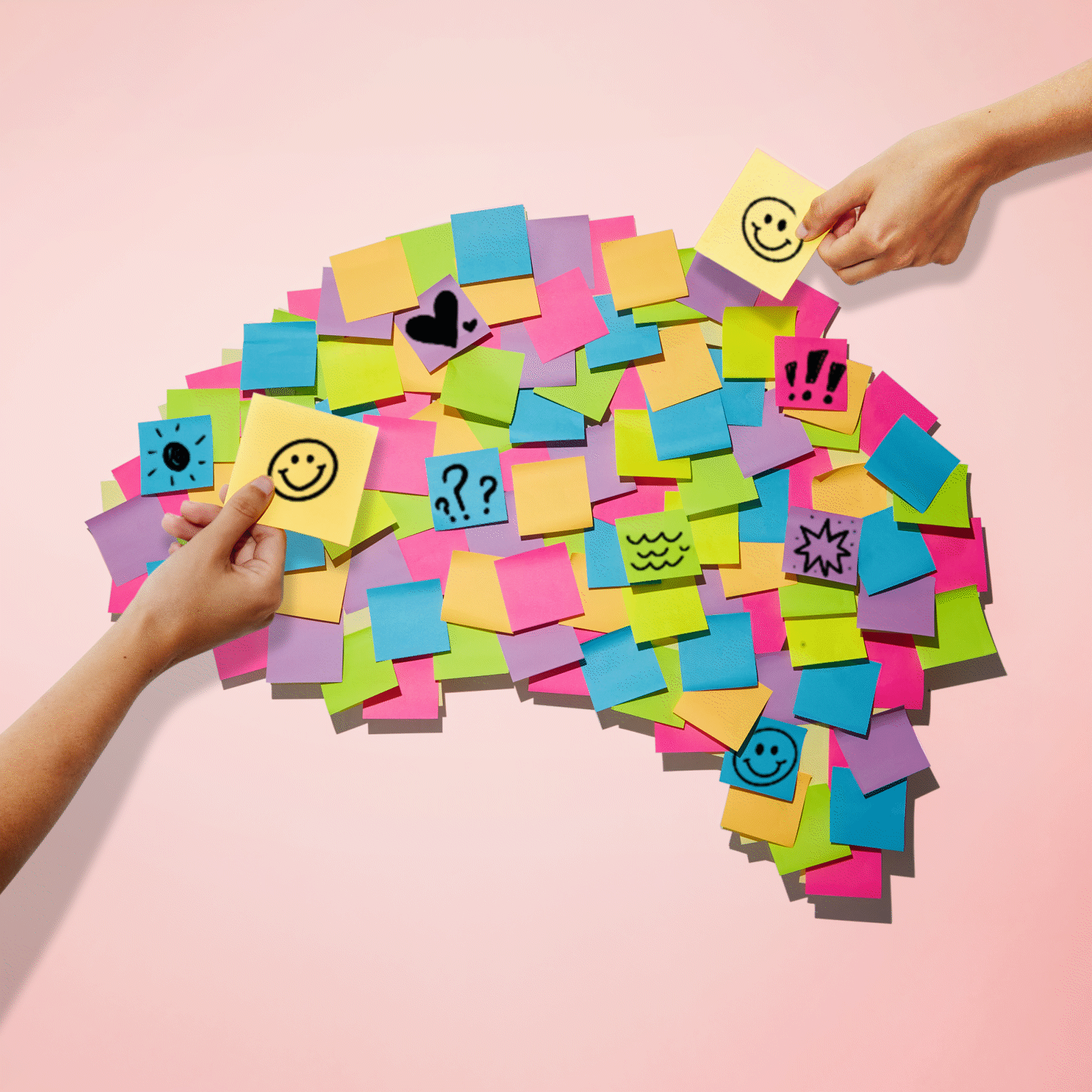 Sticky notes form a brain shape; hands add notes with doodles and symbols; background is pink.