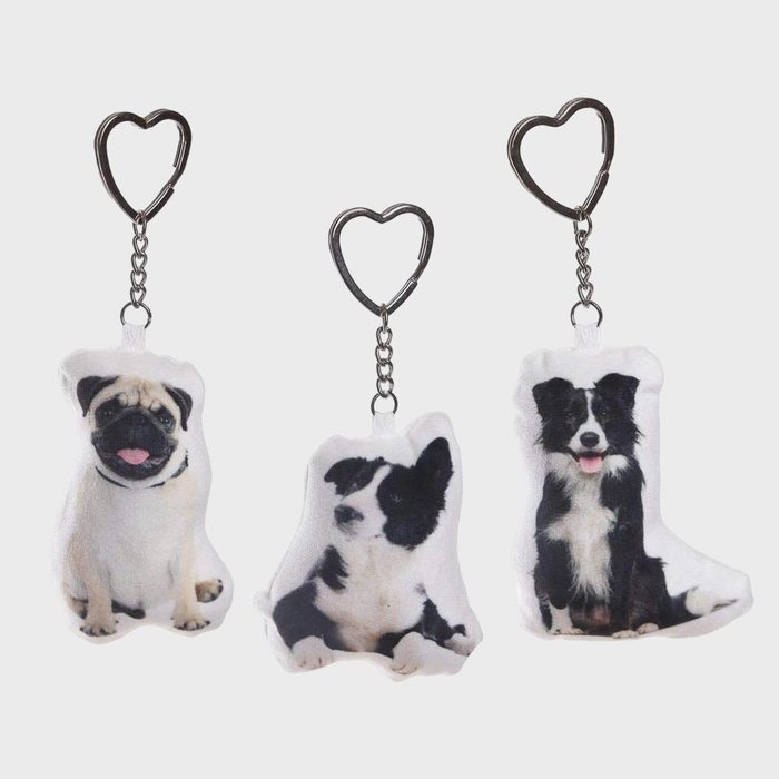 Keychains feature plush dog images dangling on heart-shaped clips, against a plain white background.