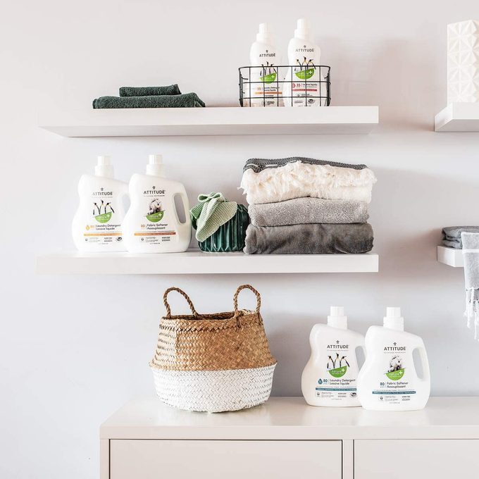 Detergent bottles sit on white shelves, holding fresh towels, basket below, in a tidy laundry room setup. Text: 