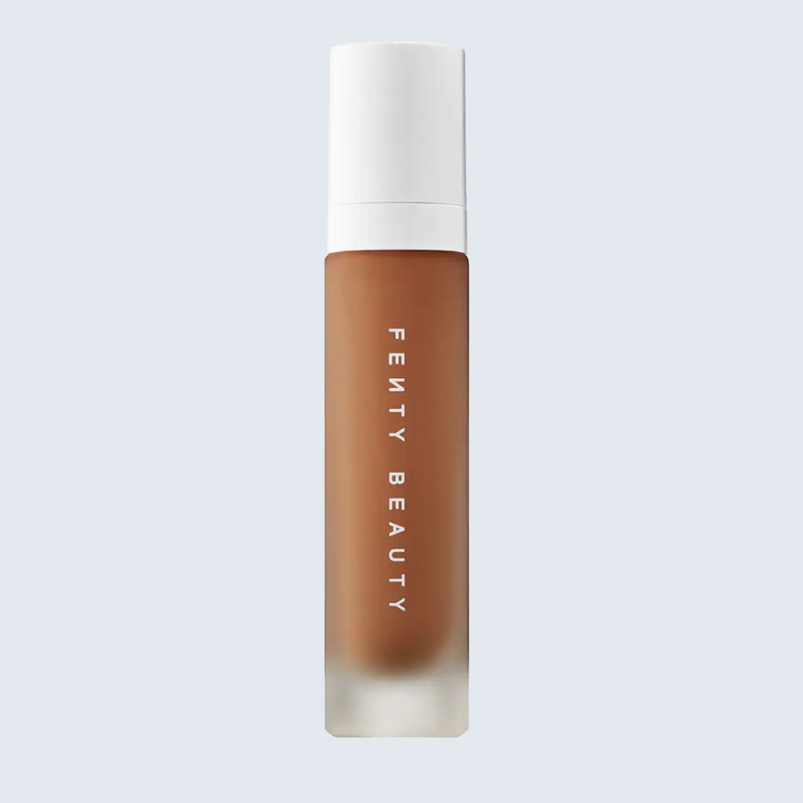 A brown cosmetic bottle labeled "FENTY BEAUTY" stands upright against a plain light background.