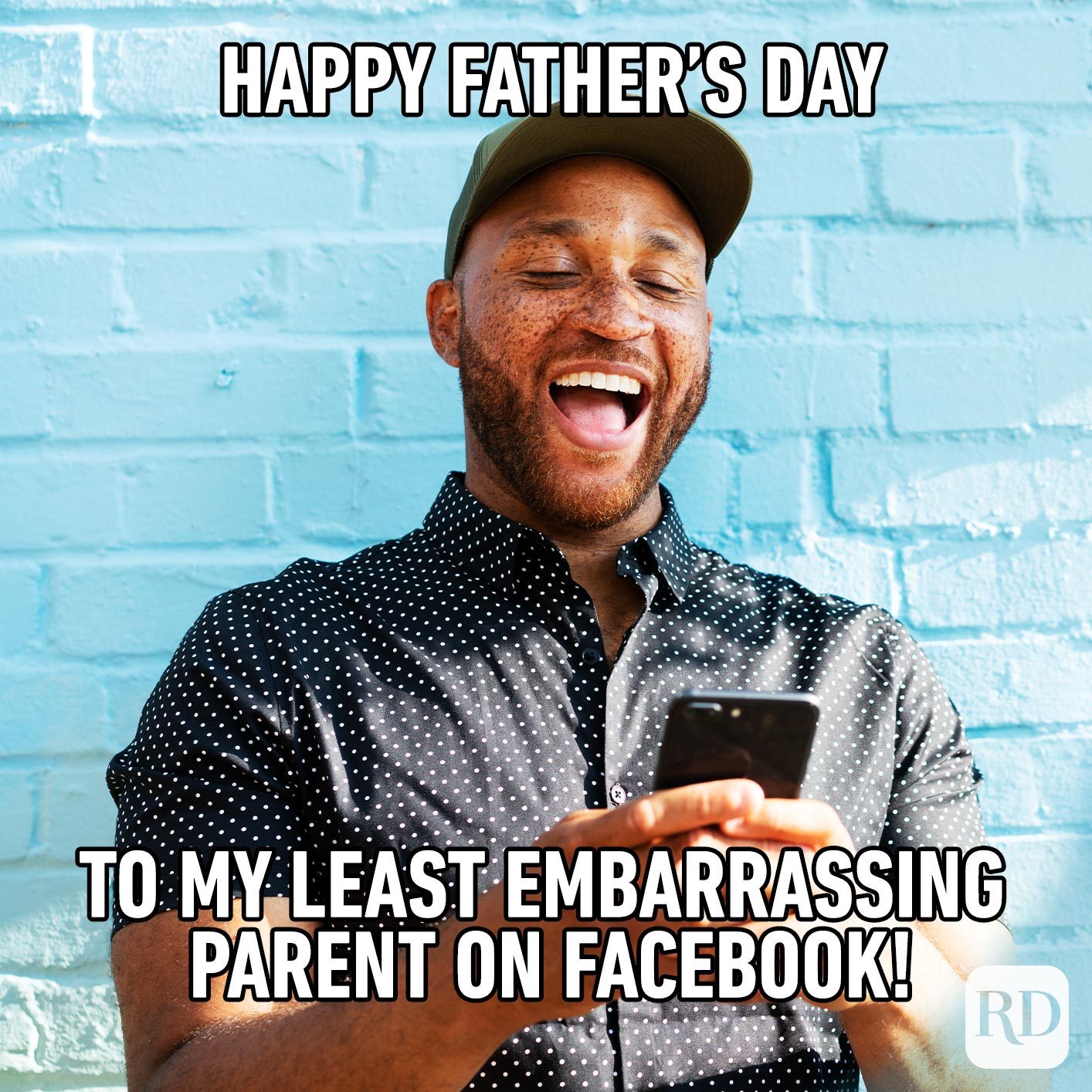 Man laughing at phone. Meme text: Happy Father’s Day to my least embarrassing parent on Facebook!