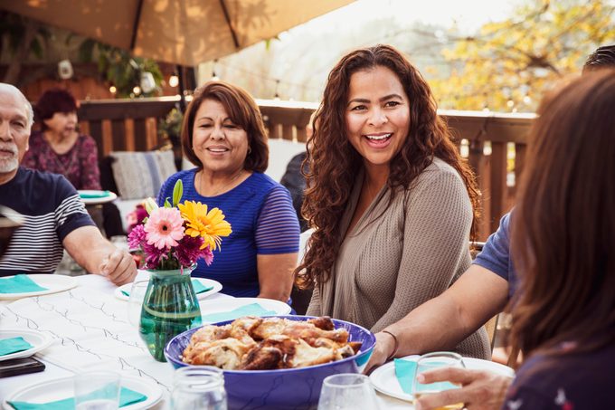 Family laughing together during outdoor dinner party