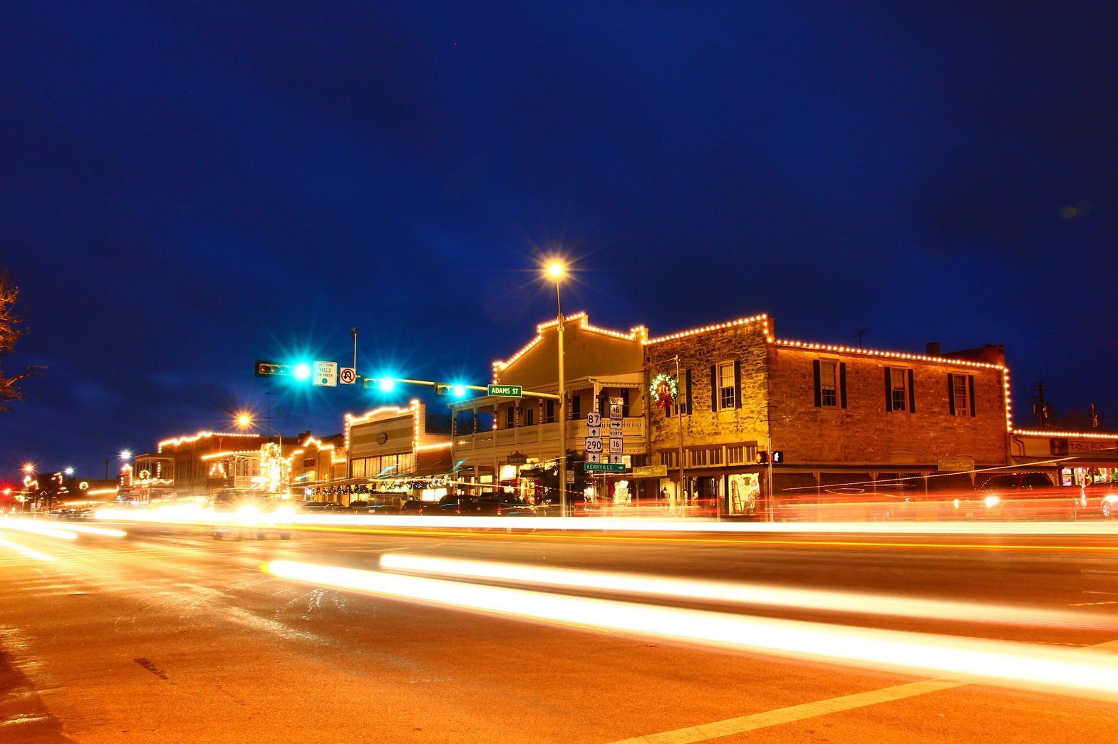 Beautiful city night scape of road and land transportation against lighting in Fredericksburg of Texas