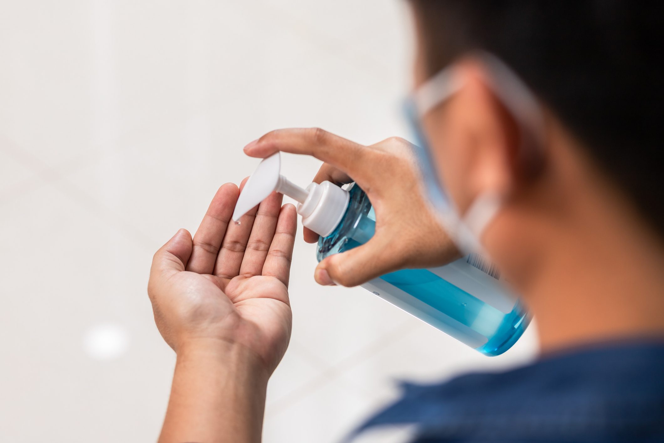 hands closeup men washing hands with alcohol gel or antibacterial soap sanitizer. Hygiene concept. prevent the spread of germs and bacteria and avoid infections corona virus [Covid-19]