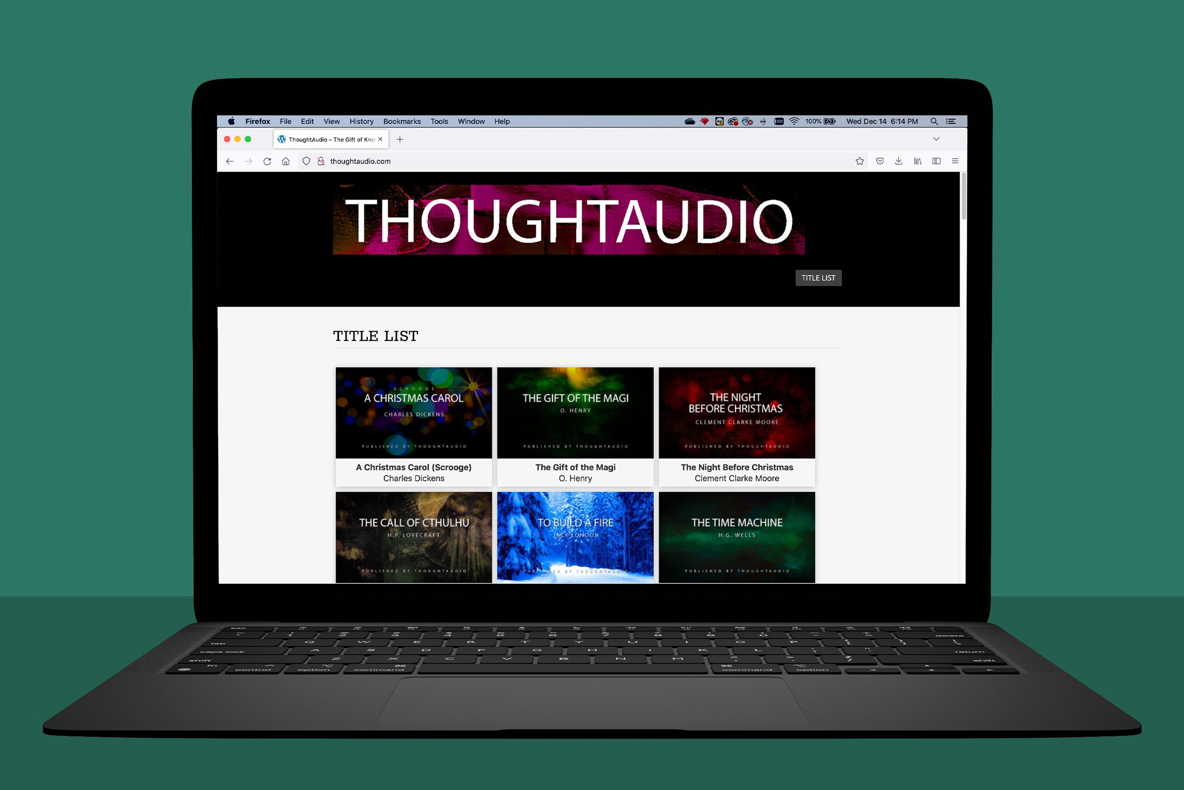 Laptop displays webpage featuring audiobook titles in a grid layout; includes "A Christmas Carol," "The Gift of the Magi," and others.