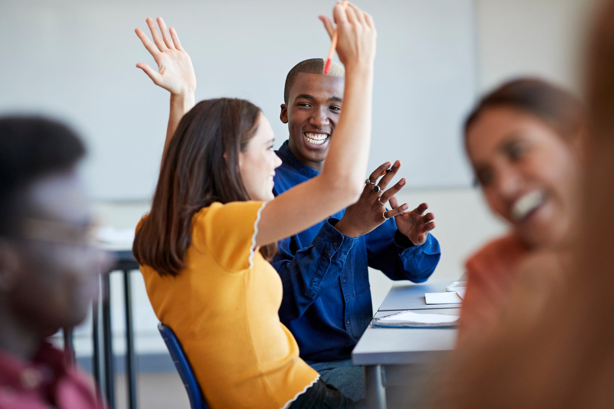 Student looking friend gesturing with arms raised