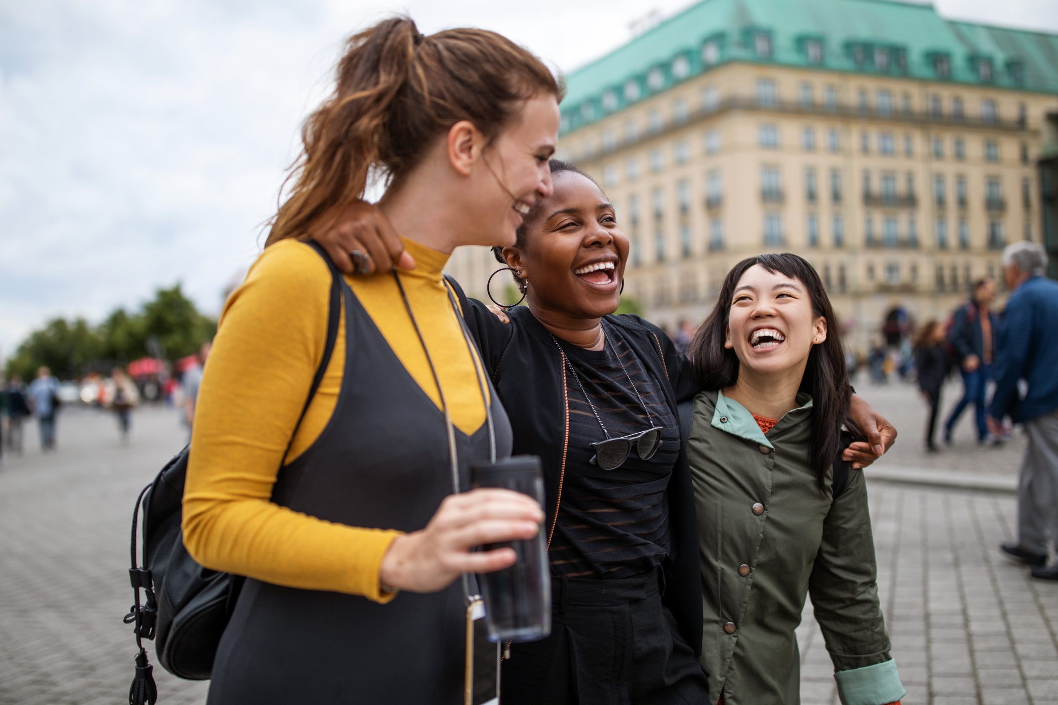 Multi-ethnic friends walking in city during vacation