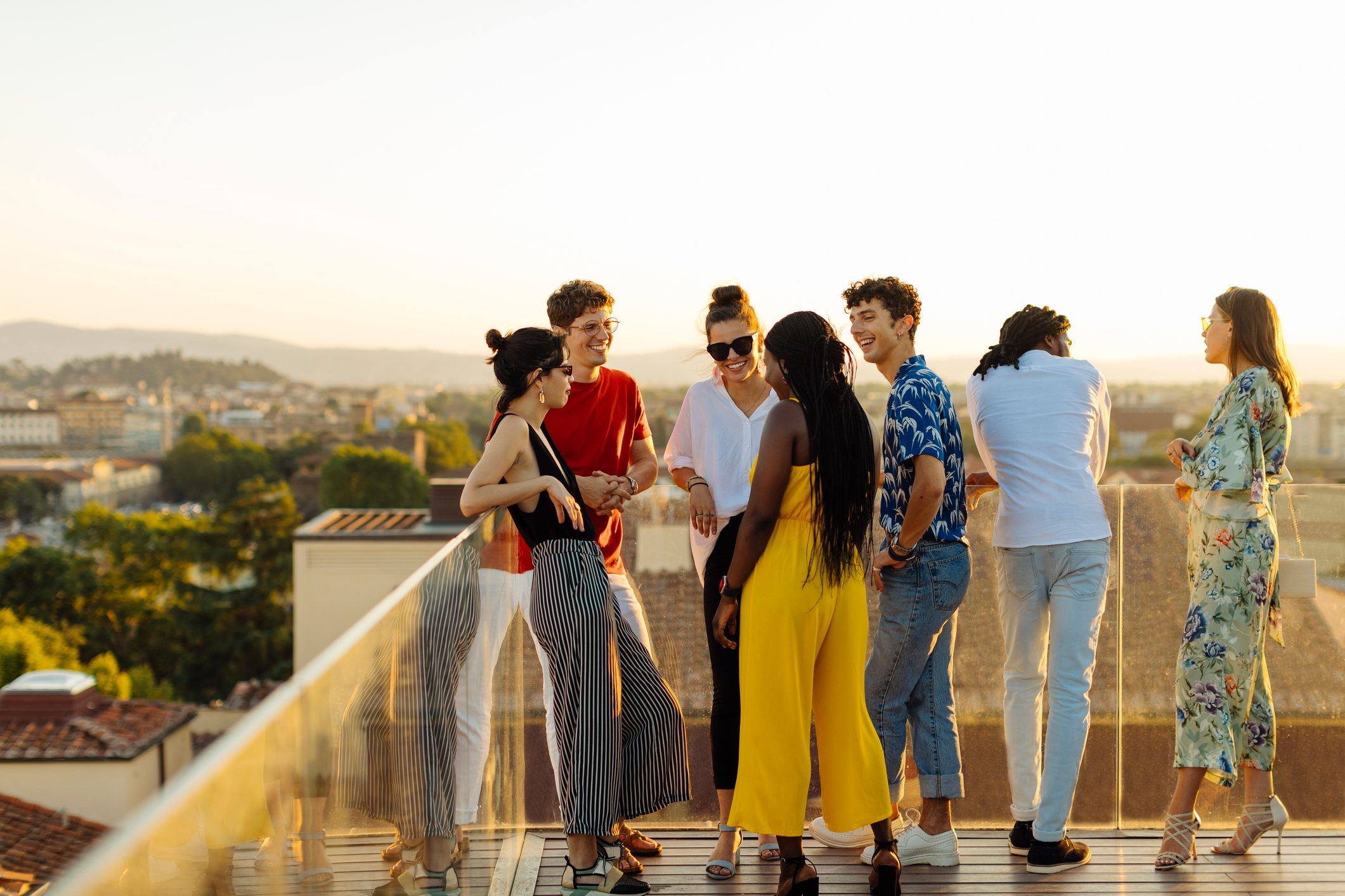 Group of happy multi-ethnic friends celebrating a party in the evening