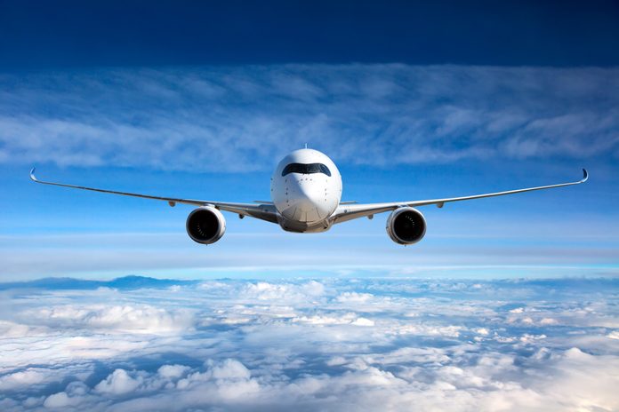 White passenger airplane in the sky.