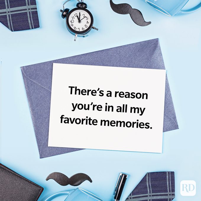 Card rests on envelopes, expressing sentiment: "There’s a reason you’re in all my favorite memories." Surrounded by a clock, pen, mustache cutouts.