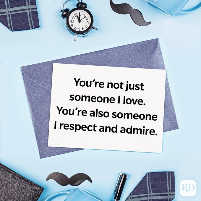 Card displays message: "You're not just someone I love. You're also someone I respect and admire." Surrounded by clock, mustache, and plaid items on blue surface.