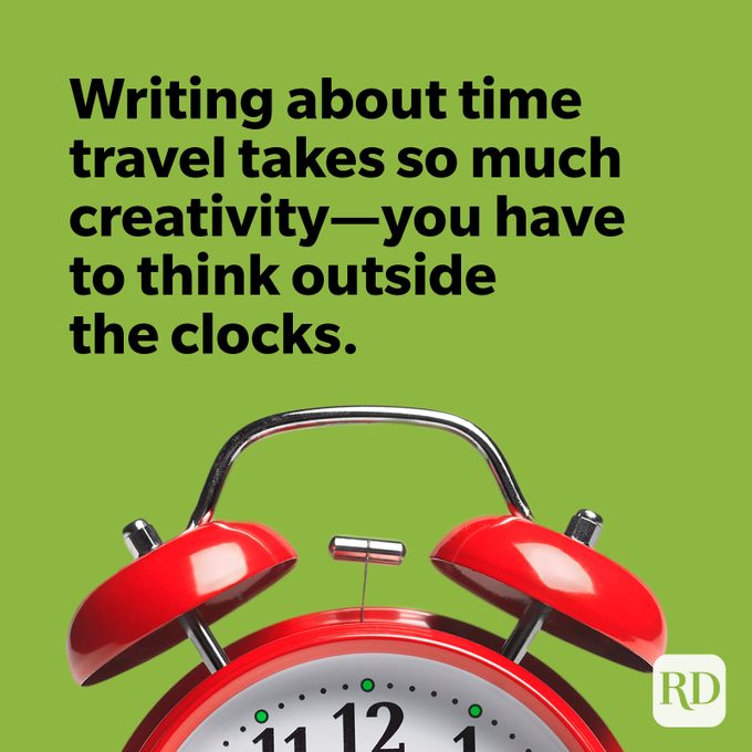 Red alarm clock on green background