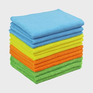 A stack of folded, colorful microfiber cloths, with blue, yellow, orange, and green layers, set against a plain white background.