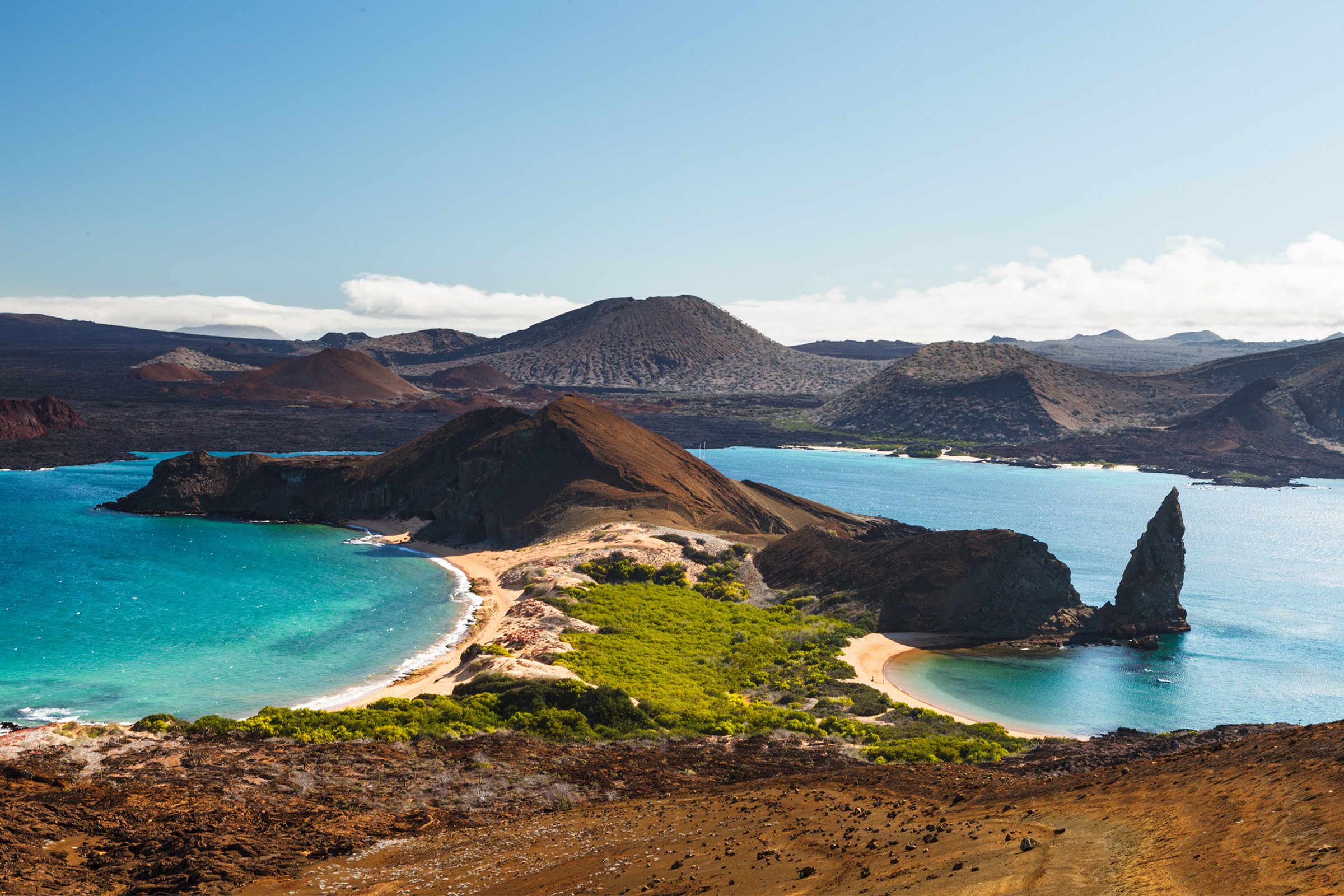View on the volcanic landscape of Bartolome Island with famous Pinnacle Rock and Golden Beach in the Gal&aacute;pagos Islands, Ecuador