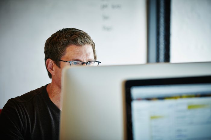 Businessman sitting at desk working on computer