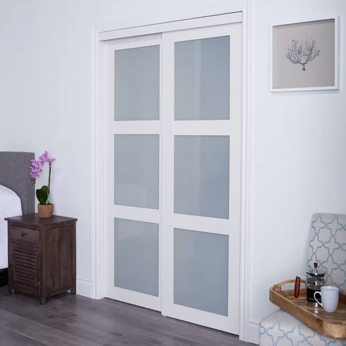 Glass Sliding Closet Doors in a bedroom