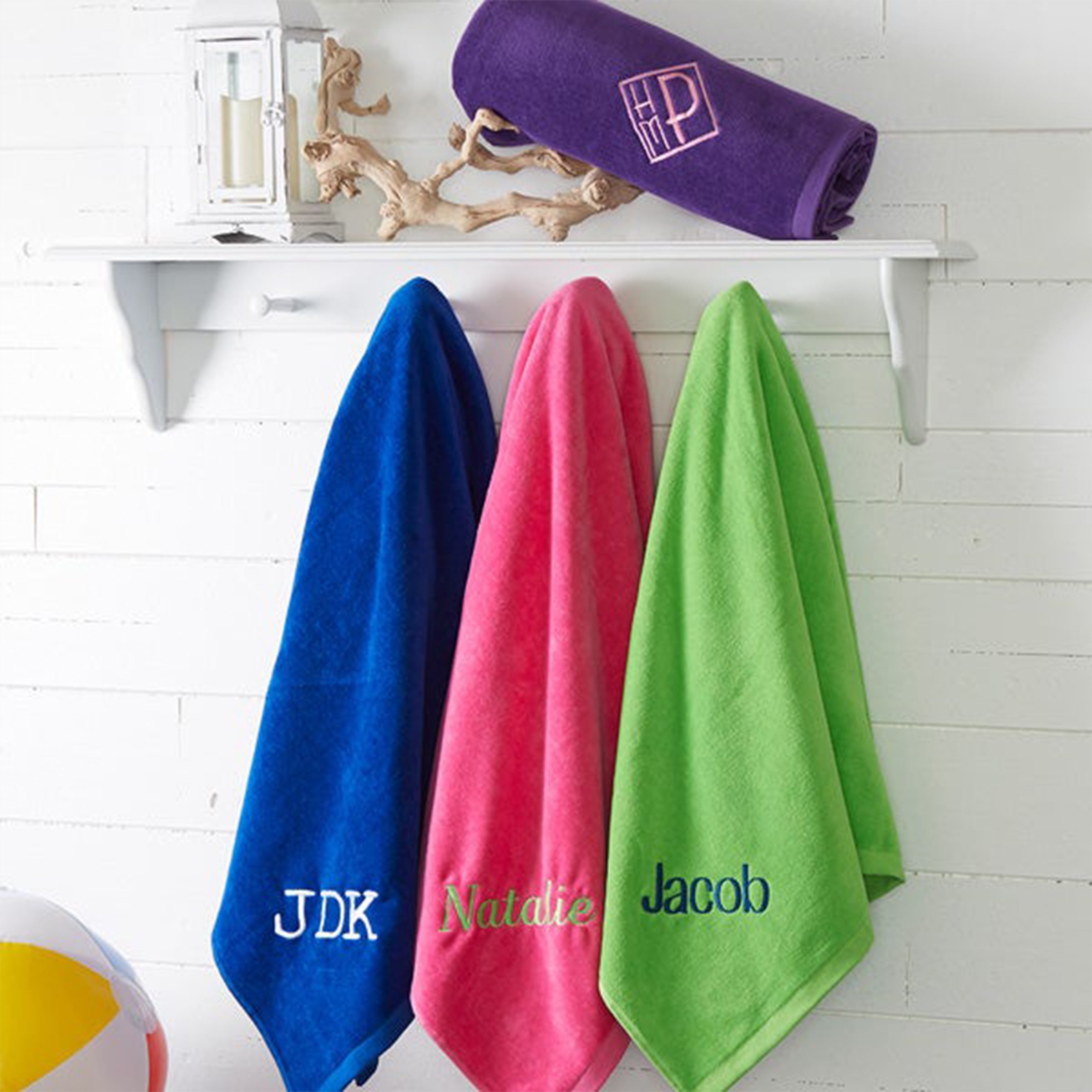 three name personalized towels handing on rack 