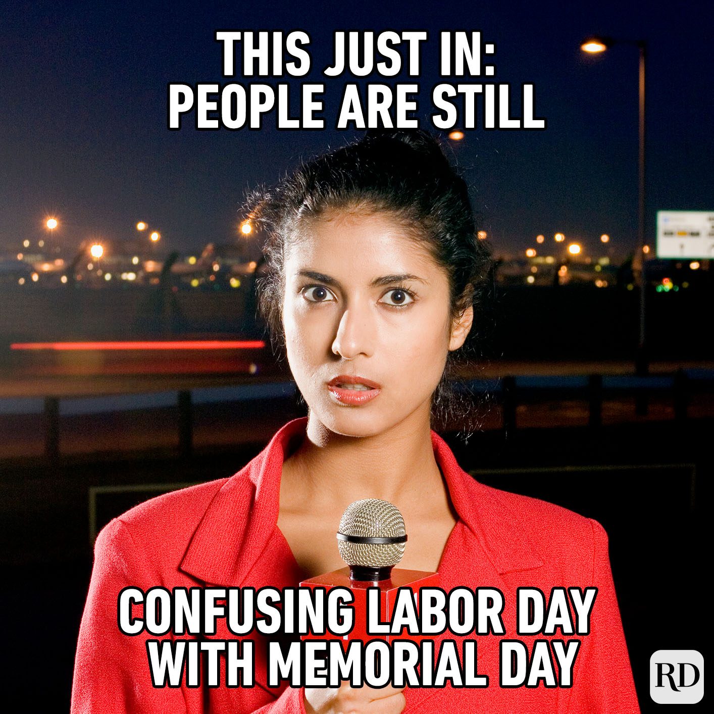 Reporter holds microphone at night; text states, "This just in: people are still confusing Labor Day with Memorial Day." Lights illuminate background.