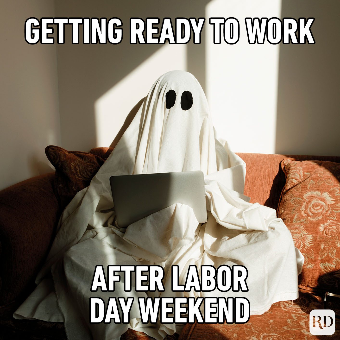 Ghost-laptop user sits on a couch, draped in a sheet, in sunlight. Text: "GETTING READY TO WORK AFTER LABOR DAY WEEKEND."