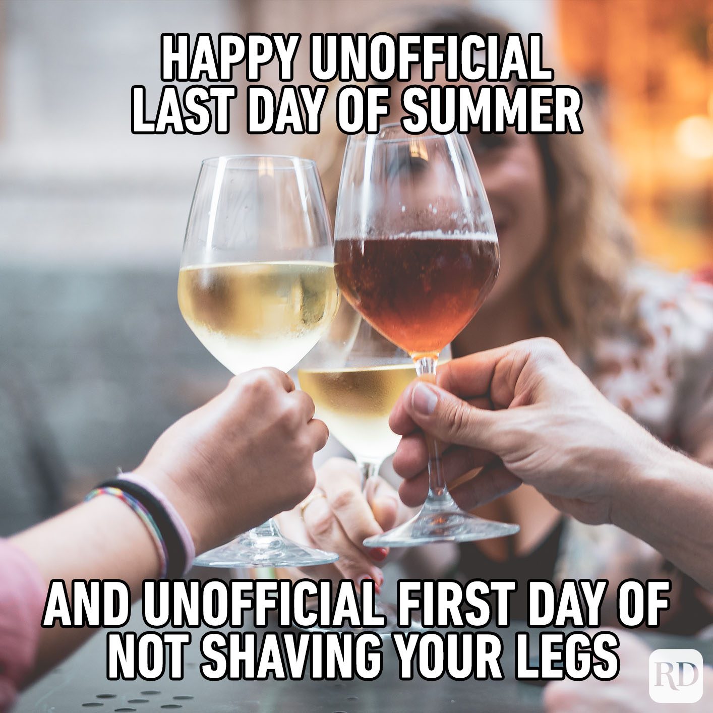 Hands clink wine glasses in a toast; text humorously notes summer's unofficial end and leg shaving cessation.