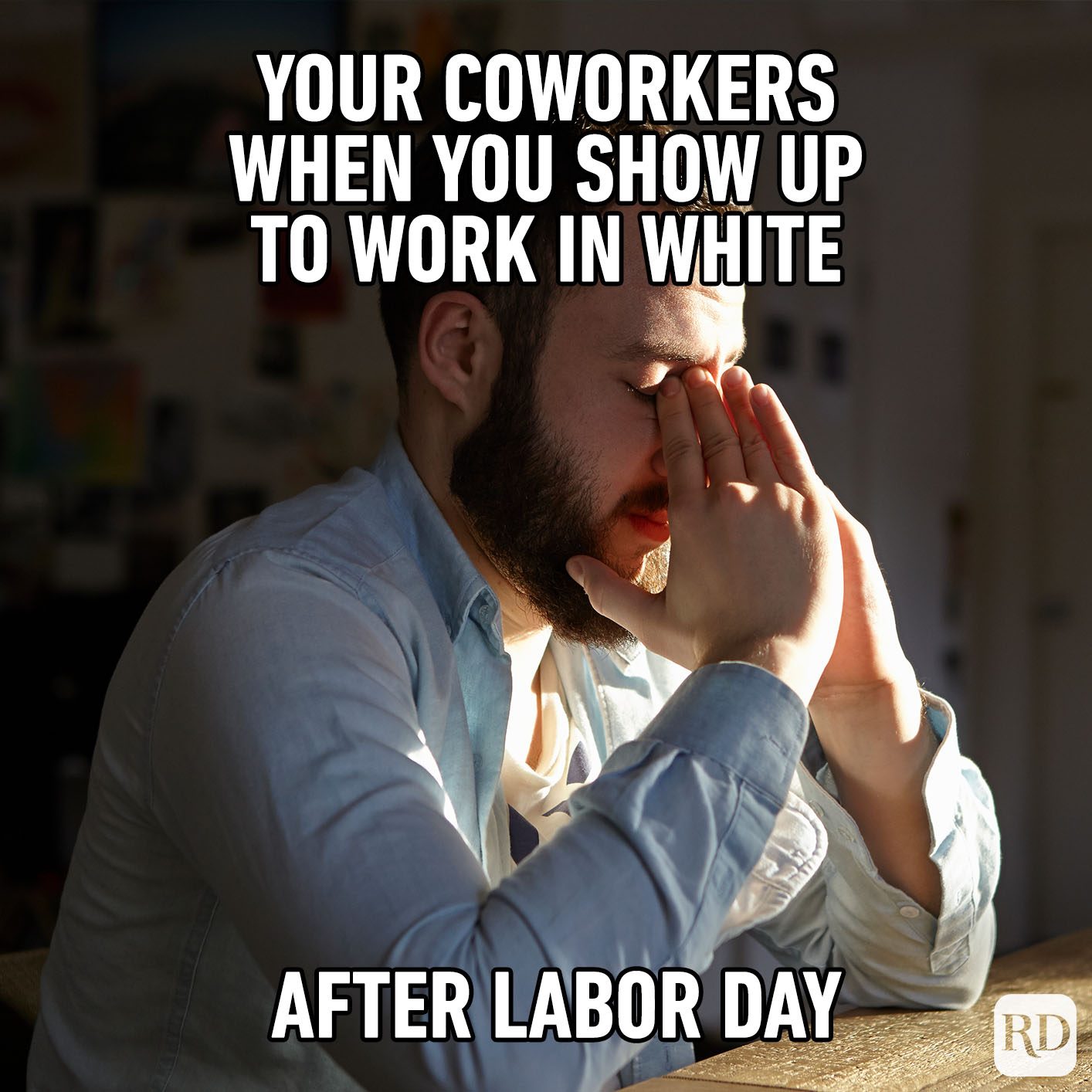 Person facepalming in sunlight, sitting at a table. Text jokingly describes coworkers reacting to someone wearing white after Labor Day.