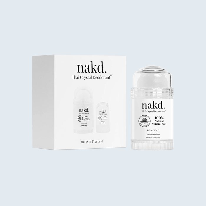 Deodorant sits next to its box; both display â€œnakd.â€ branding, emphasizing â€œ100% Natural Mineral Saltâ€ and â€œMade in Thailandâ€ in a minimalist design.