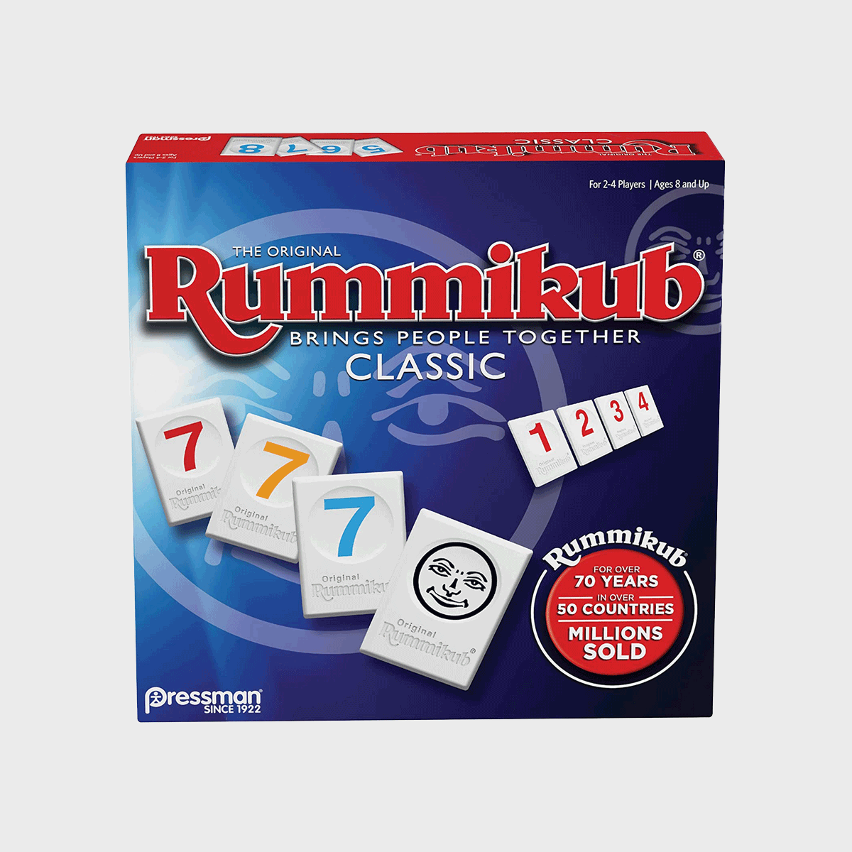 Box shows Rummikub game tiles displaying numbers, surrounded by promotional text about its popularity and longevity, set against a blue background.